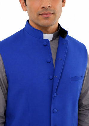  Man wearing a blue vest over a gray shirt on a white background