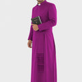 Man wearing a purple robe holding a book on a white background