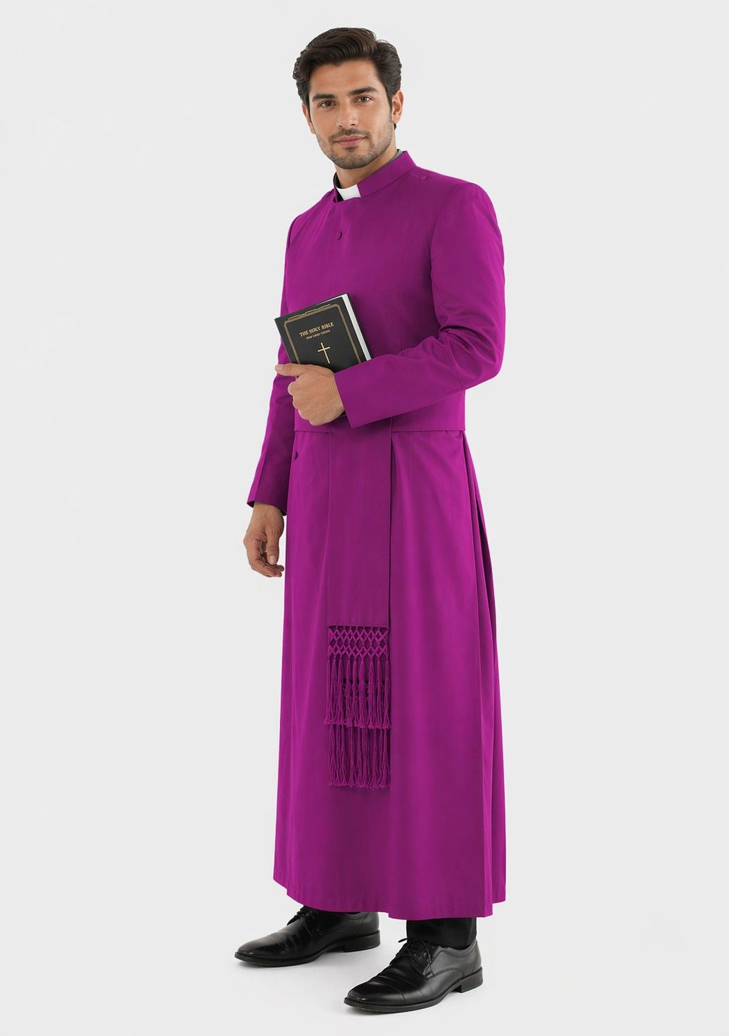 Man wearing a purple robe holding a book on a white background