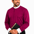 Man wearing a magenta shirt with a white collar holding a black book on a white background
