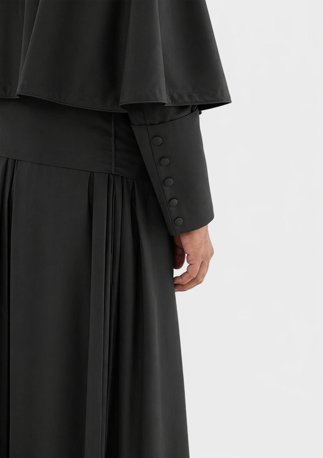 Black coat with button details on a white background