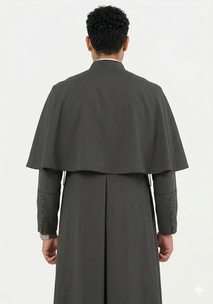 Person wearing a long gray coat with a cape on a white background
