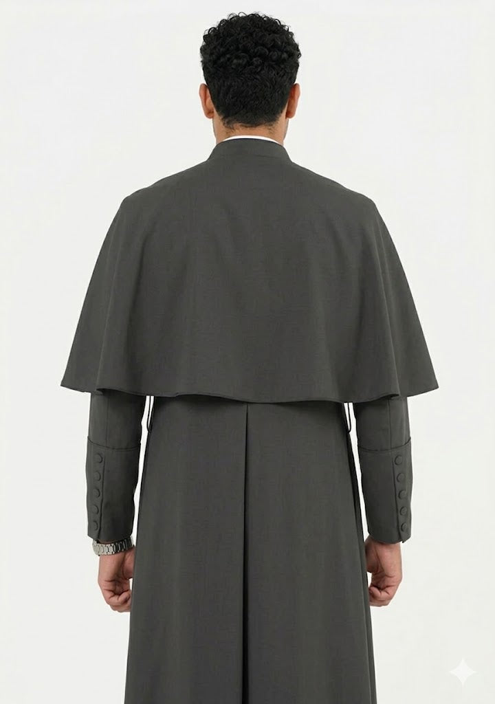 Person wearing a long gray coat with a cape on a white background