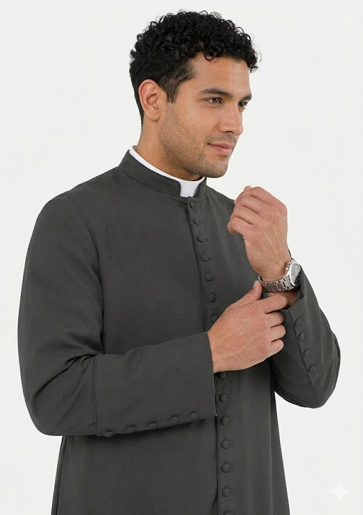 Man wearing a gray traditional clerical robe on a white background