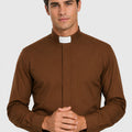 Man wearing a brown clerical shirt with a white collar on a gray background