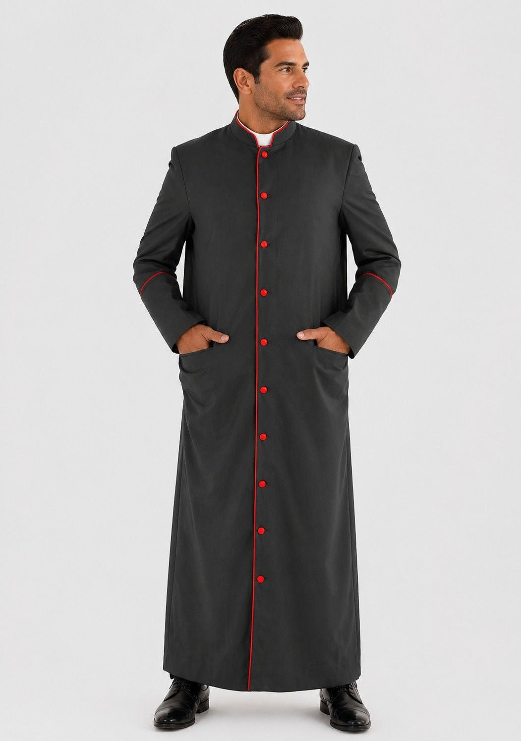 Man wearing a black robe with red buttons on a white background