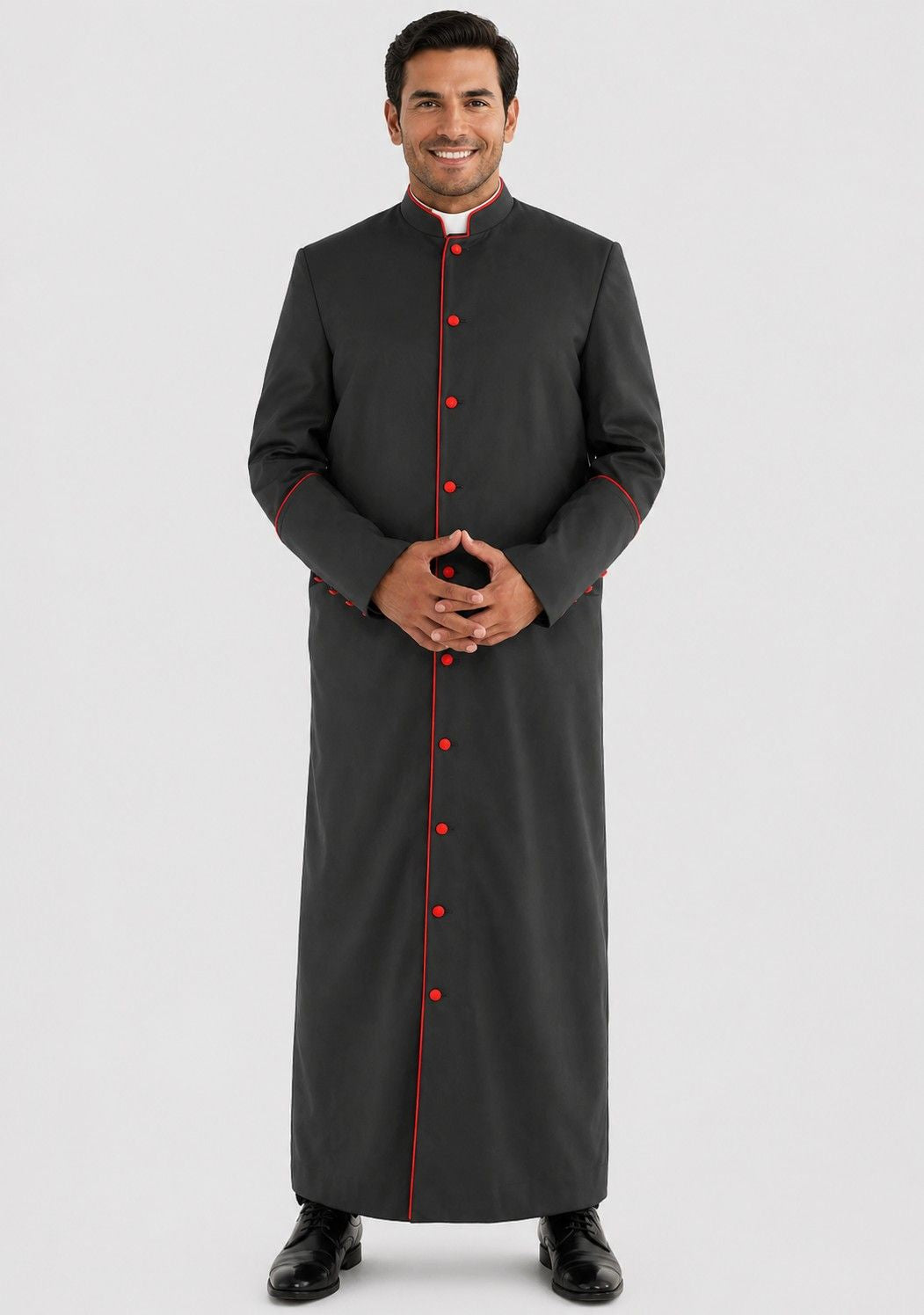 Man wearing a black clerical robe with red buttons on a gray background