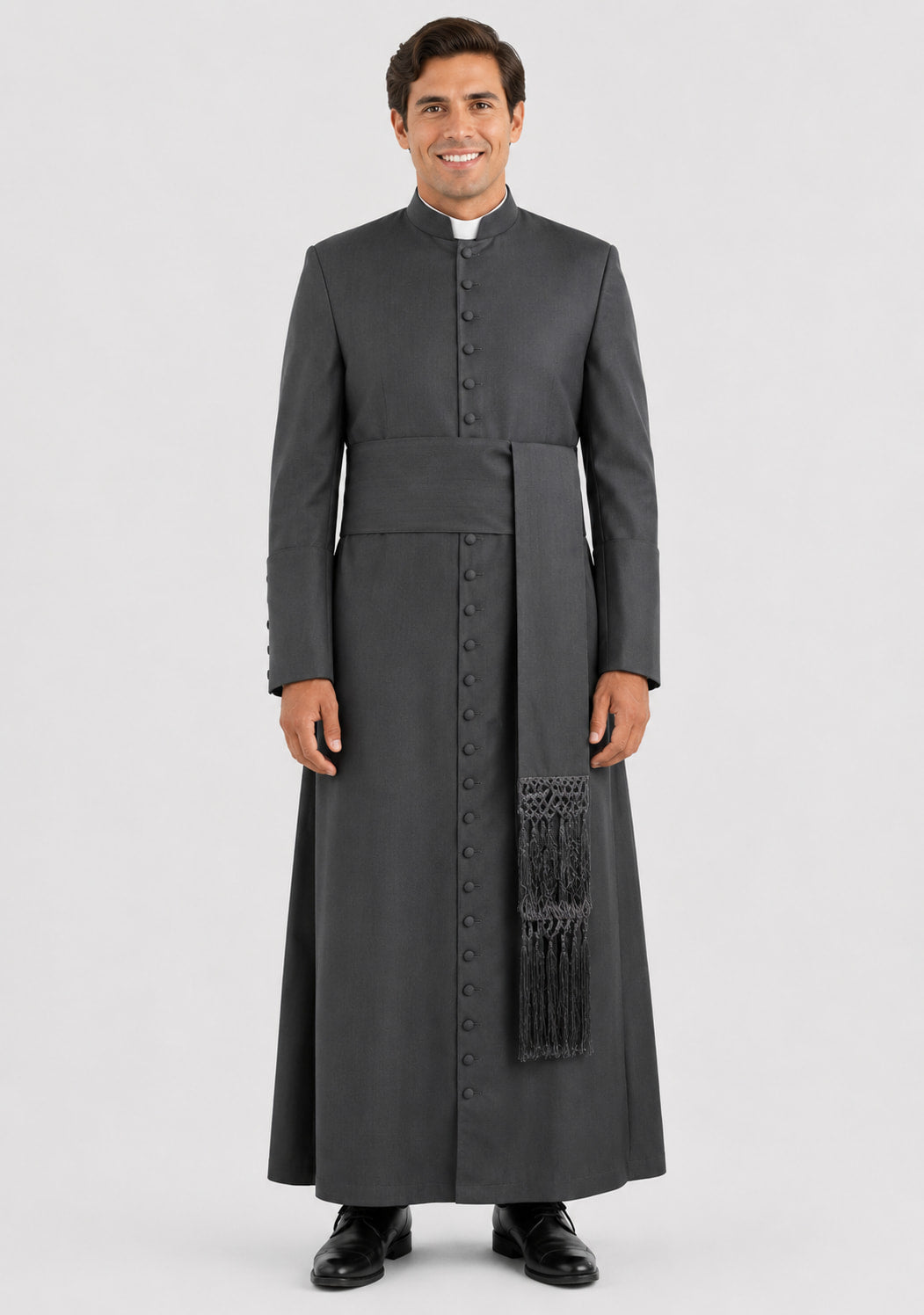 Man wearing a gray priest's robe with a stole on a white background