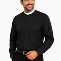 Man wearing a black long-sleeve clerical shirt with a white collar against a light gray background