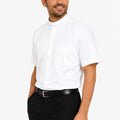 Man wearing a white clerical shirt and black pants on a white background