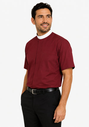 Man wearing a maroon clerical shirt with a white collar on a plain background