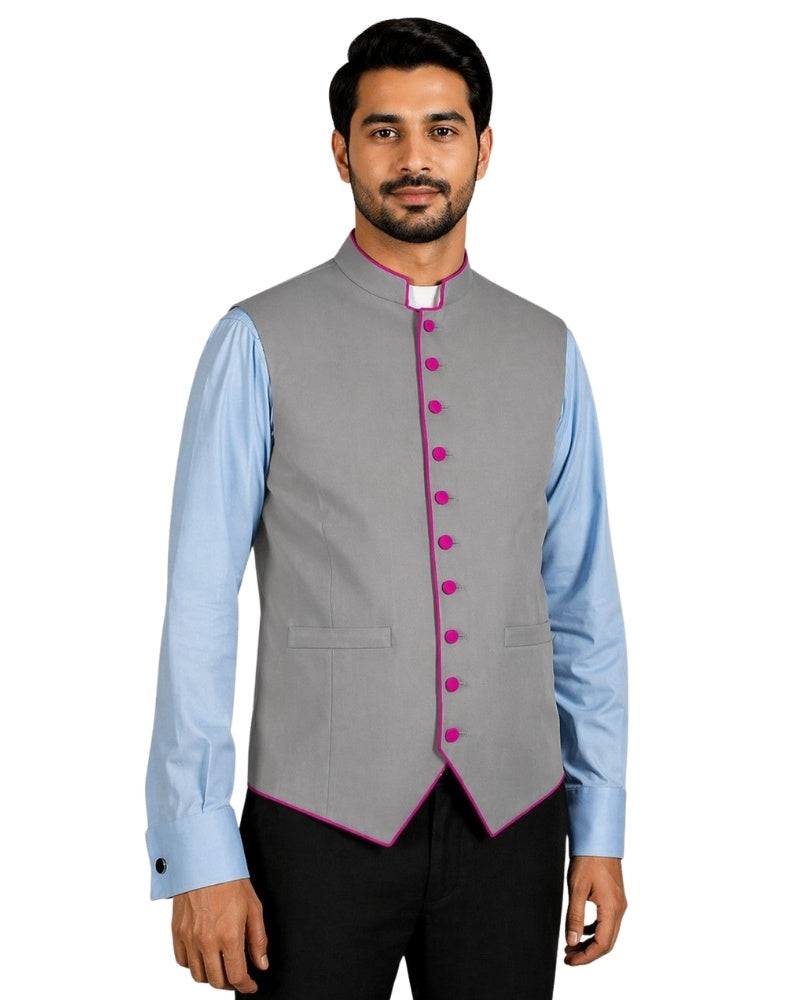 Man wearing a gray vest with purple buttons over a light blue shirt on a white background.