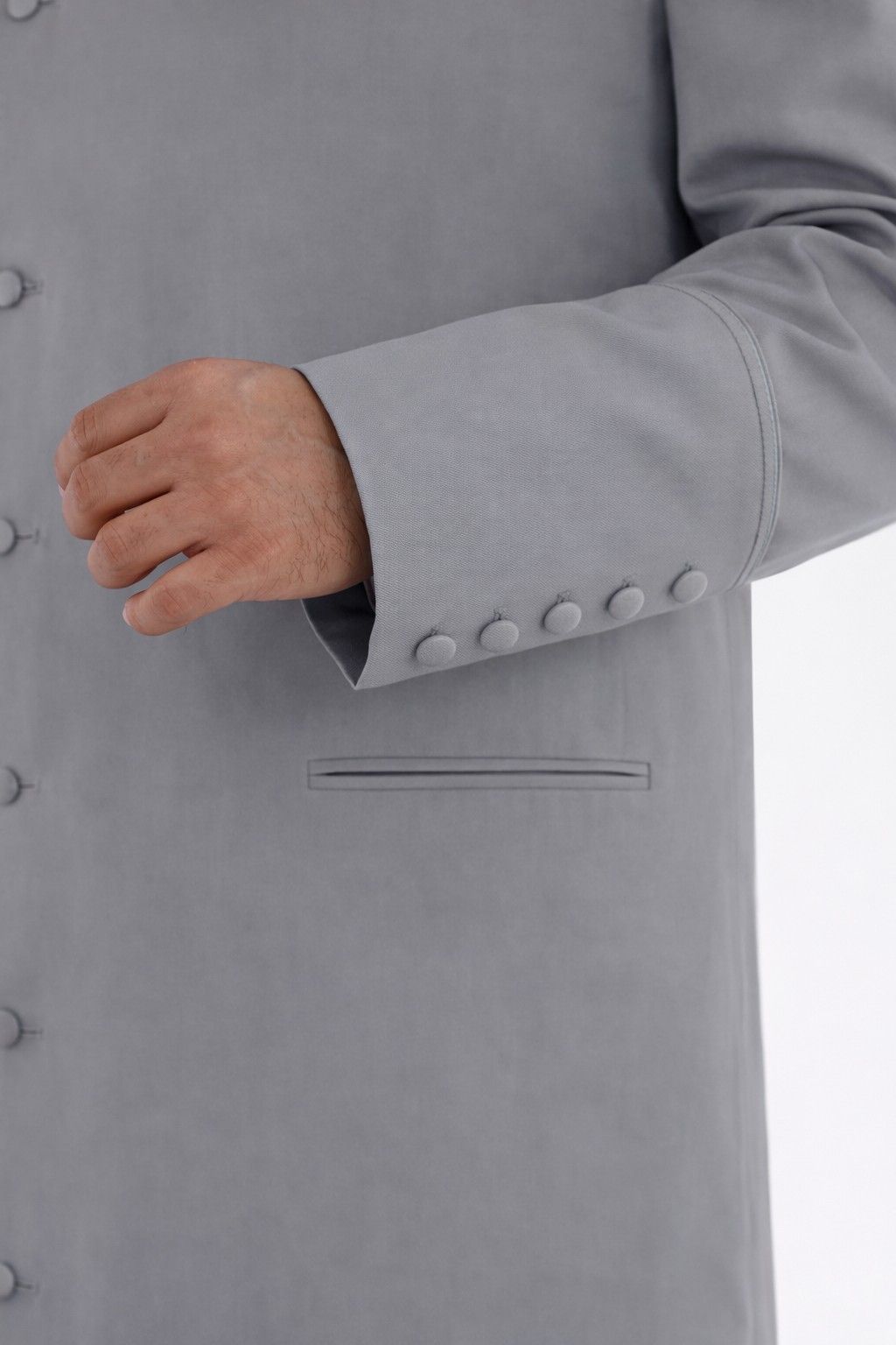 Close-up of a gray robe with buttons on a white background