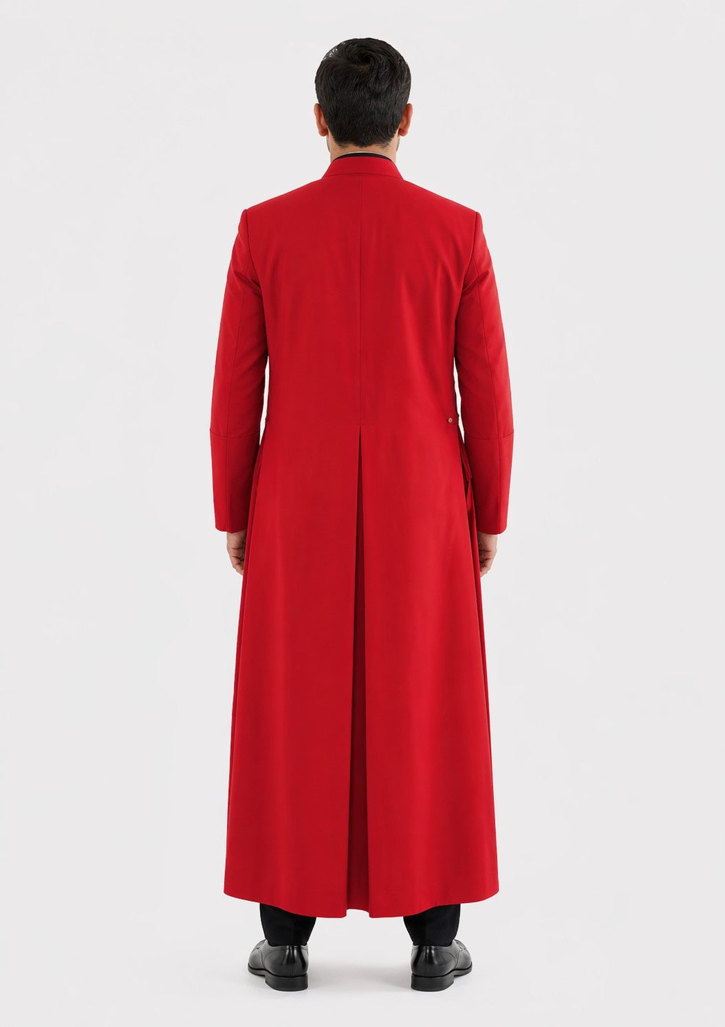 Person wearing a long red robe on a white background