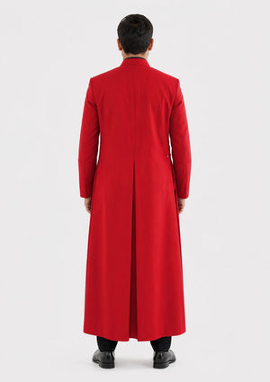 Person wearing a long red robe on a white background