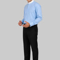 Man wearing a light blue dress shirt and black pants on a plain background