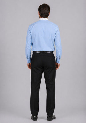 Man wearing a light blue shirt and black pants on a gray background