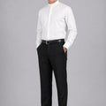 Man wearing a white dress shirt and black pants on a gray background