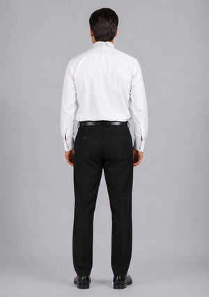 Man wearing a white dress shirt and black pants on a gray background