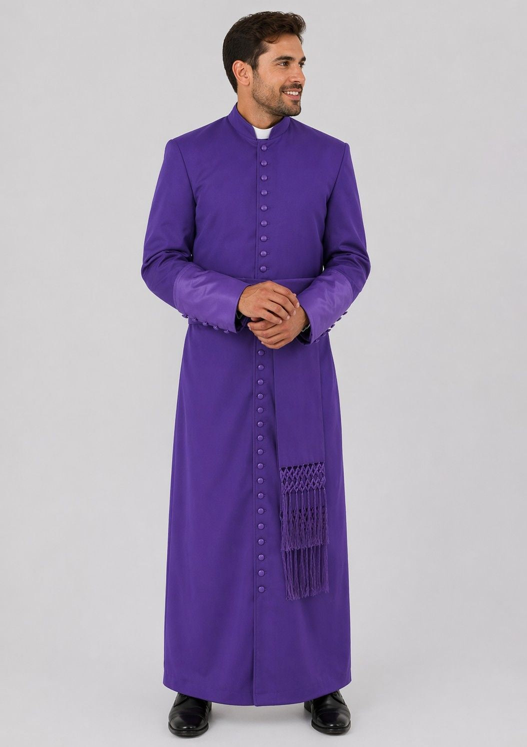 Man wearing a purple robe with a white shirt underneath on a gray background