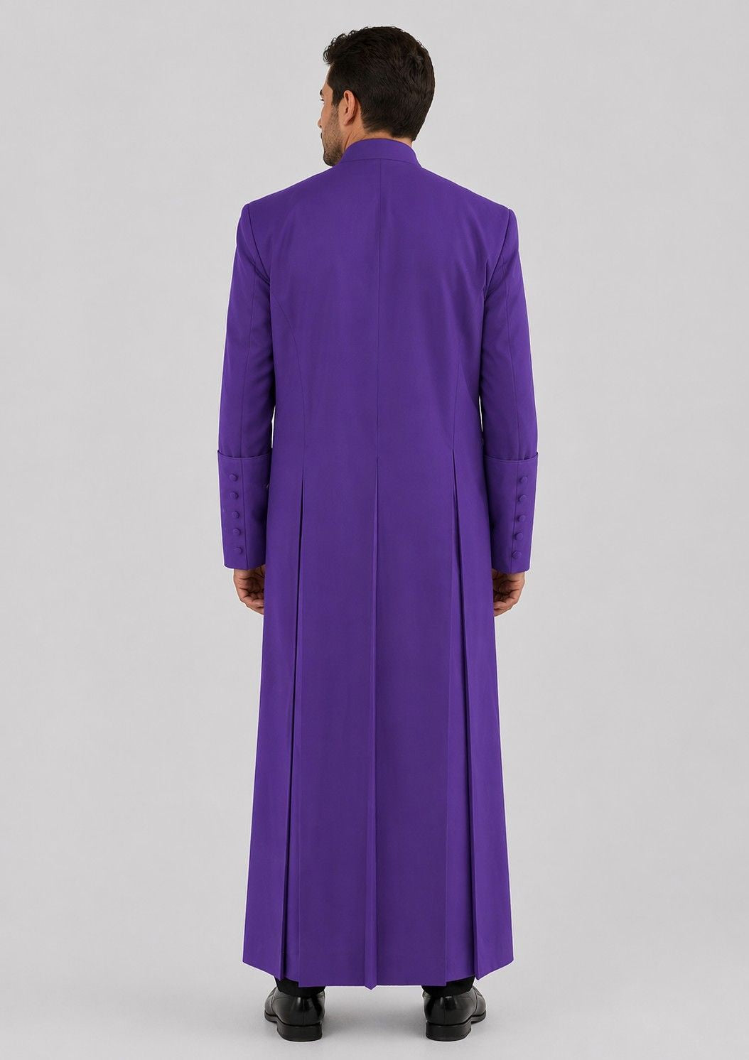 Man wearing a long purple robe on a gray background