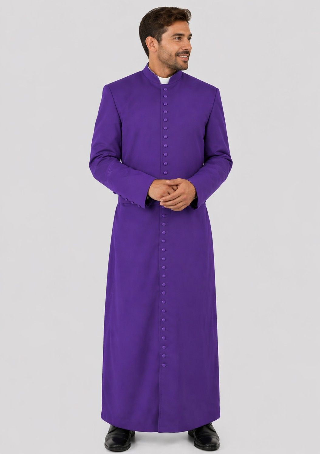 Man wearing a purple cassock on a light gray background
