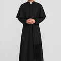 Man wearing a black priest's robe on a white background