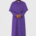 Man wearing a purple liturgical vestment on a white background