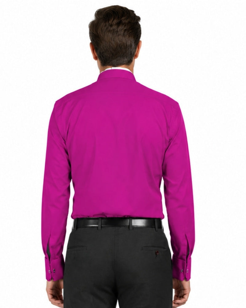 Man wearing a bright magenta shirt and black pants on a white background