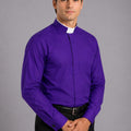 Man wearing a purple shirt with a clerical collar against a gray background