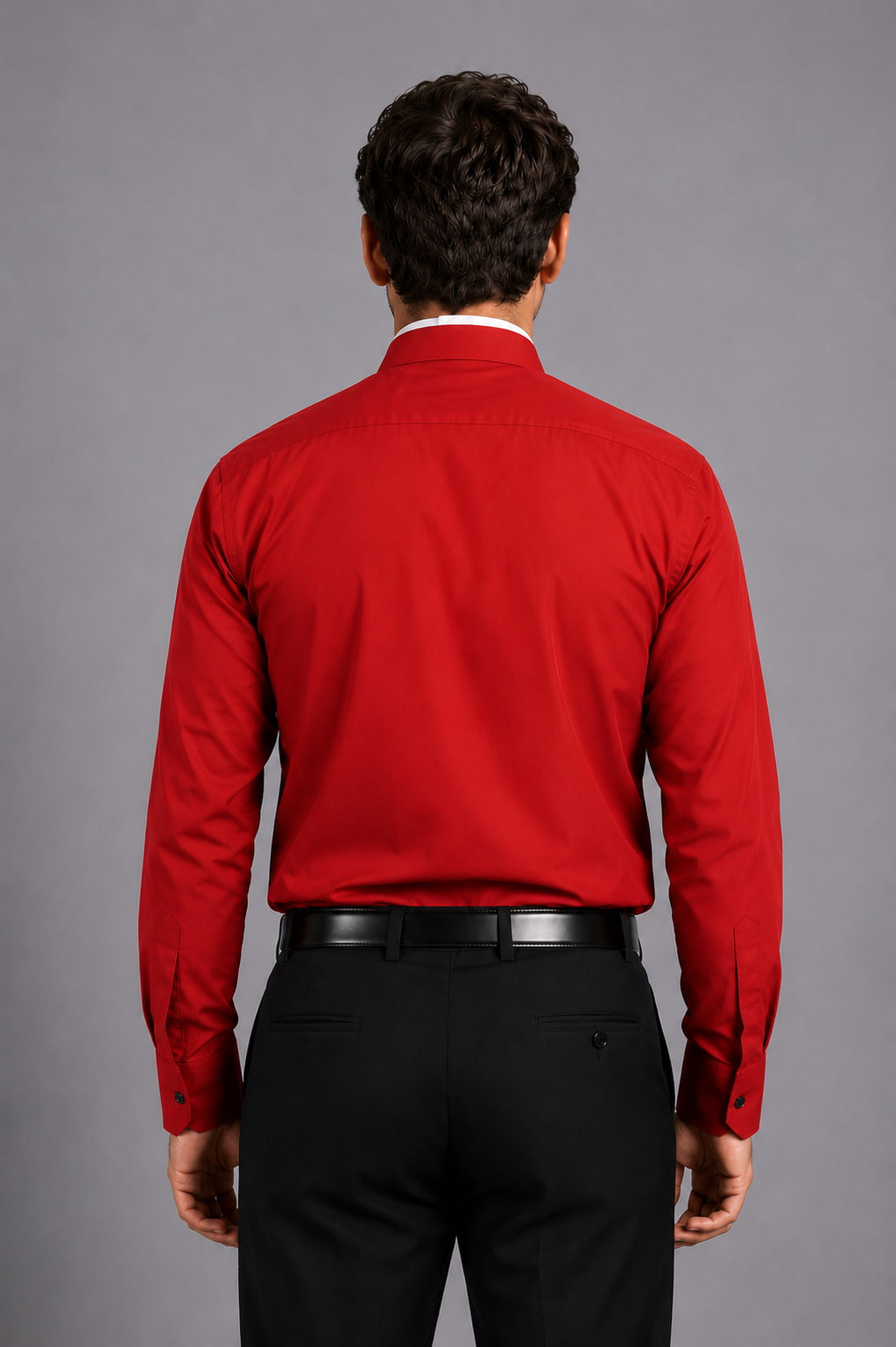 Men wearing a red shirt and black pants against a gray background