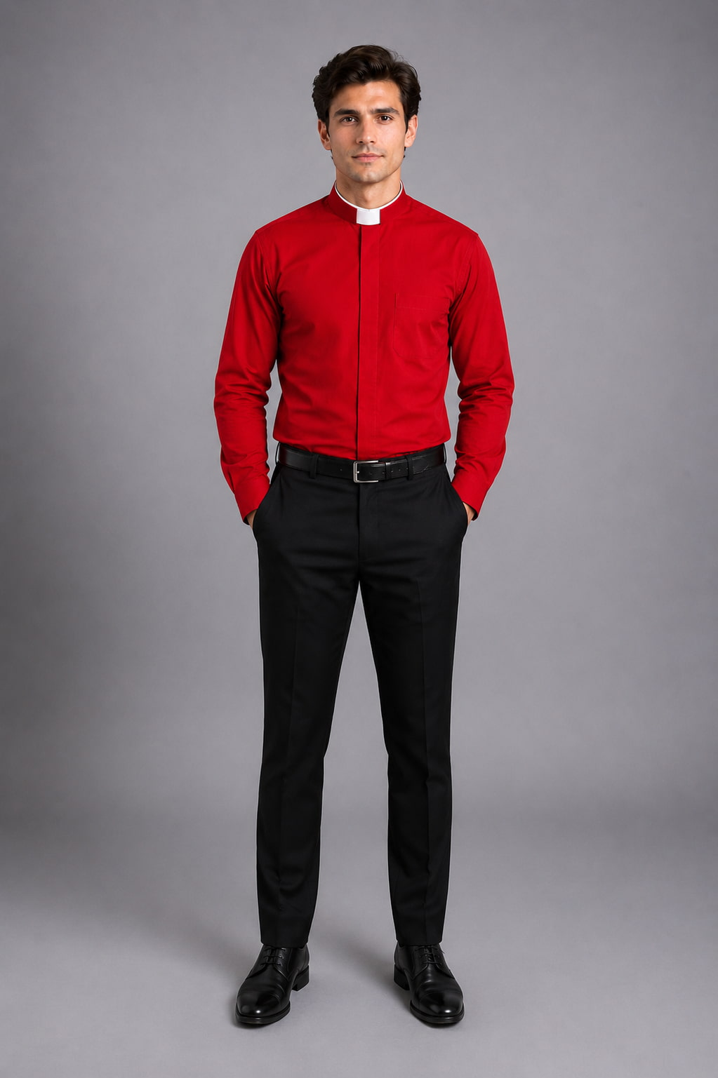 Man wearing a red shirt and black pants on a gray background