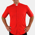 Man wearing a red clerical shirt with a white collar on a white background