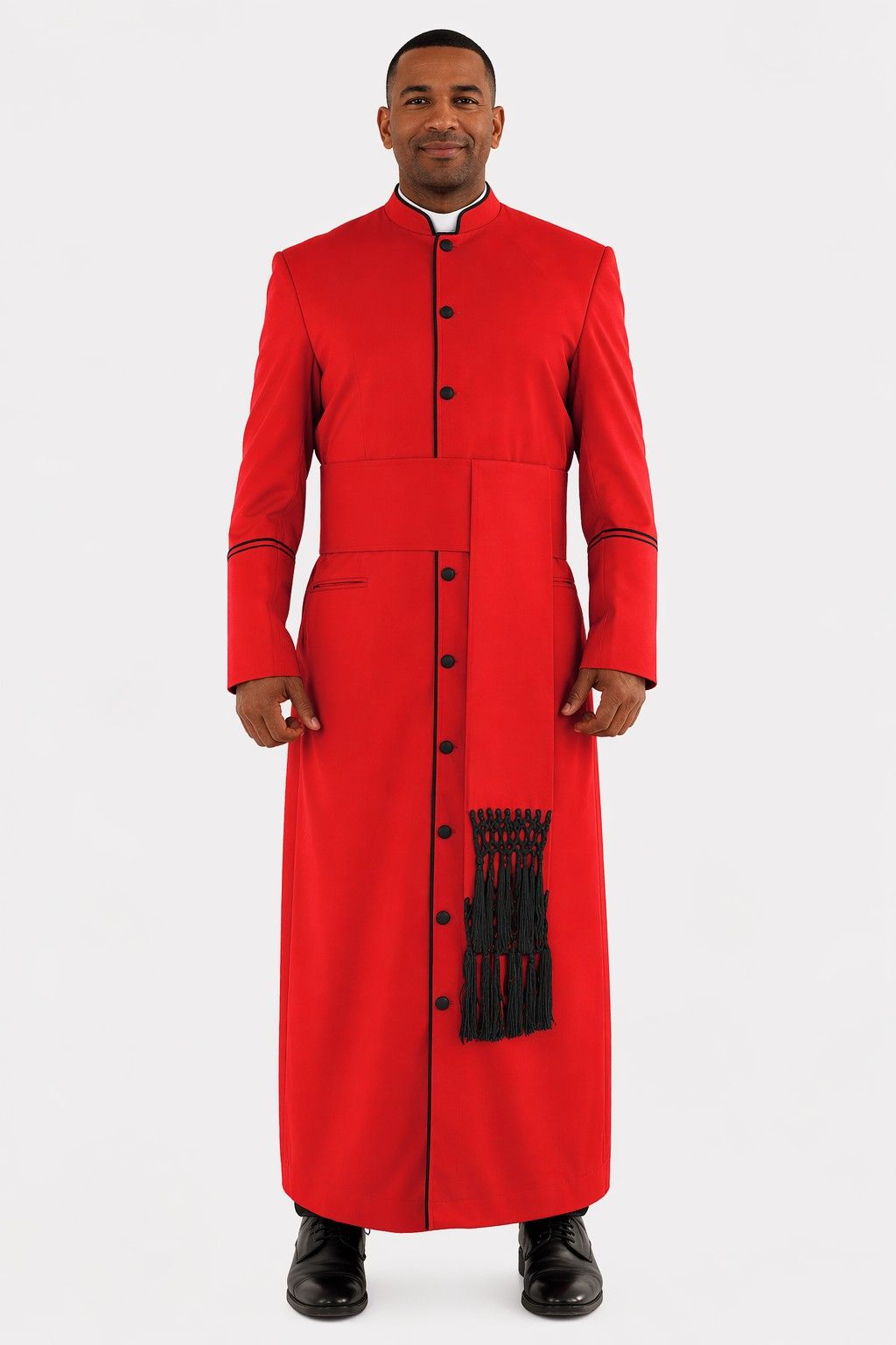 Man wearing a red robe with black buttons and trim on a white background