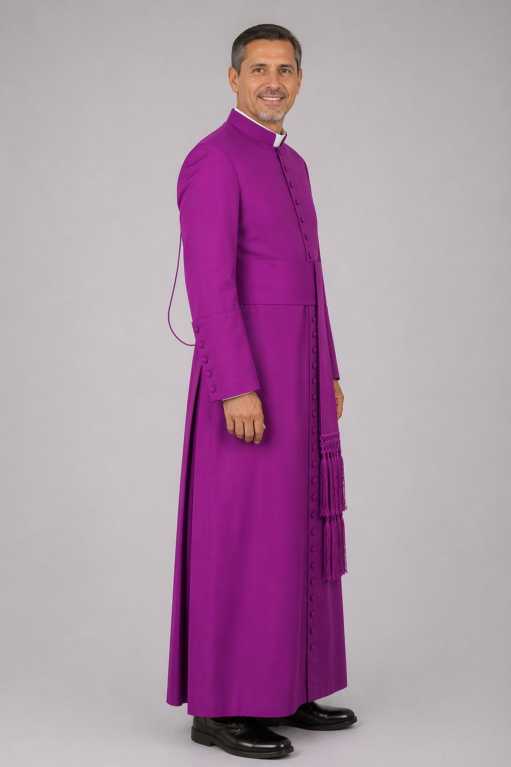 Man wearing a purple robe on a gray background