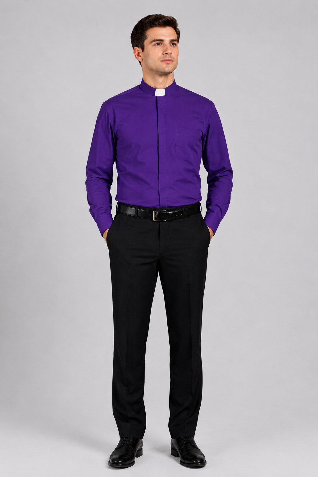 Man wearing a purple shirt with a clerical collar and black pants on a white background