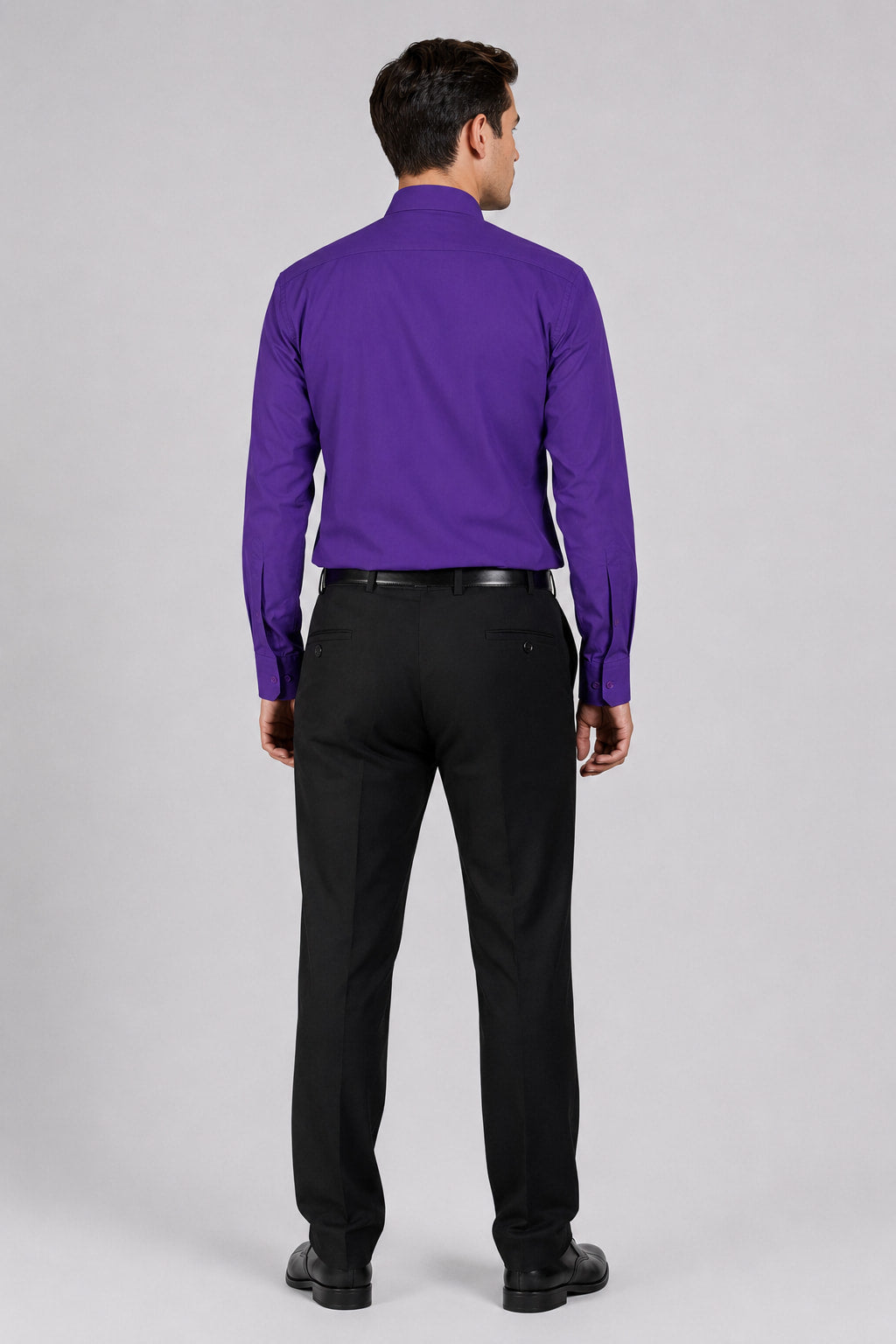 Man wearing a purple shirt and black pants on a white background