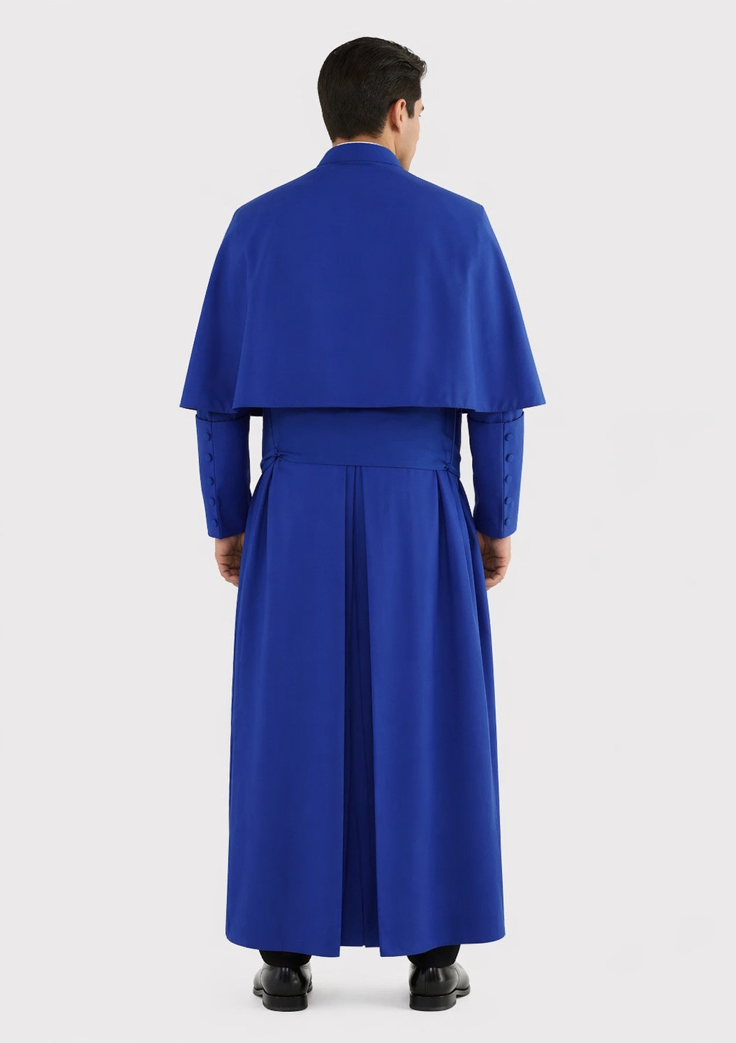 Person wearing a blue outfit with a cape on a white background