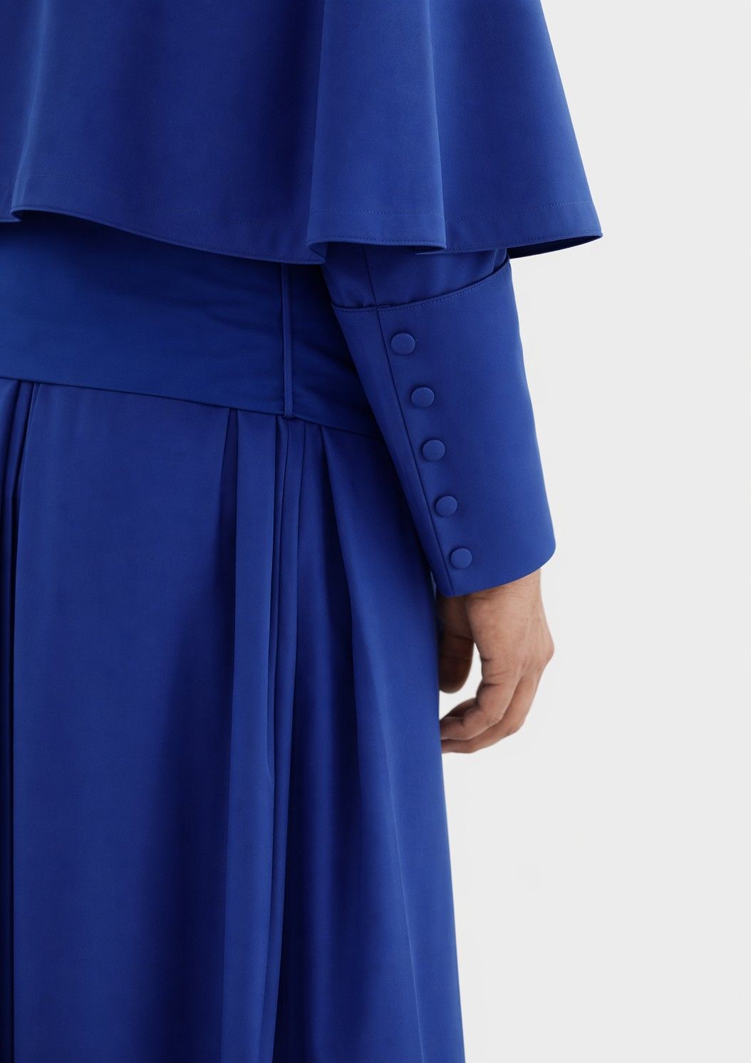 Blue outfit with buttons on a white background