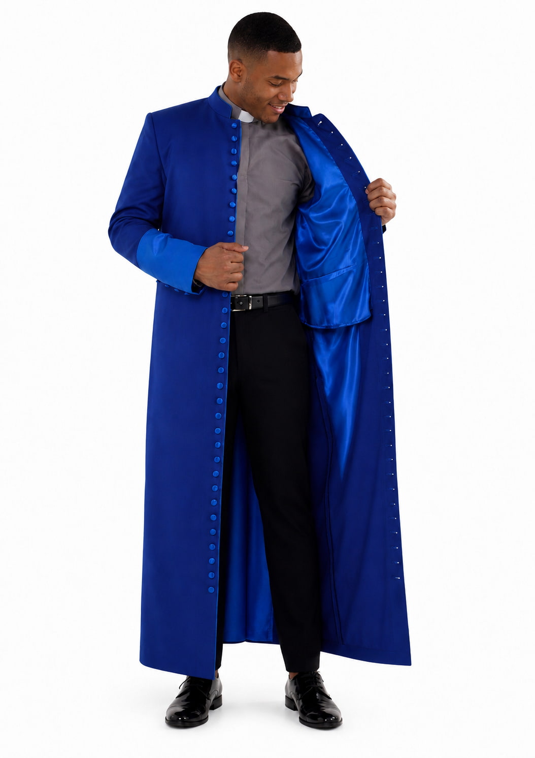 Man wearing a long blue robe over a gray shirt on a white background