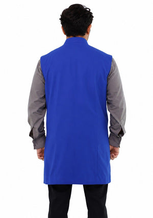 Man wearing a blue vest over a gray shirt on a white background