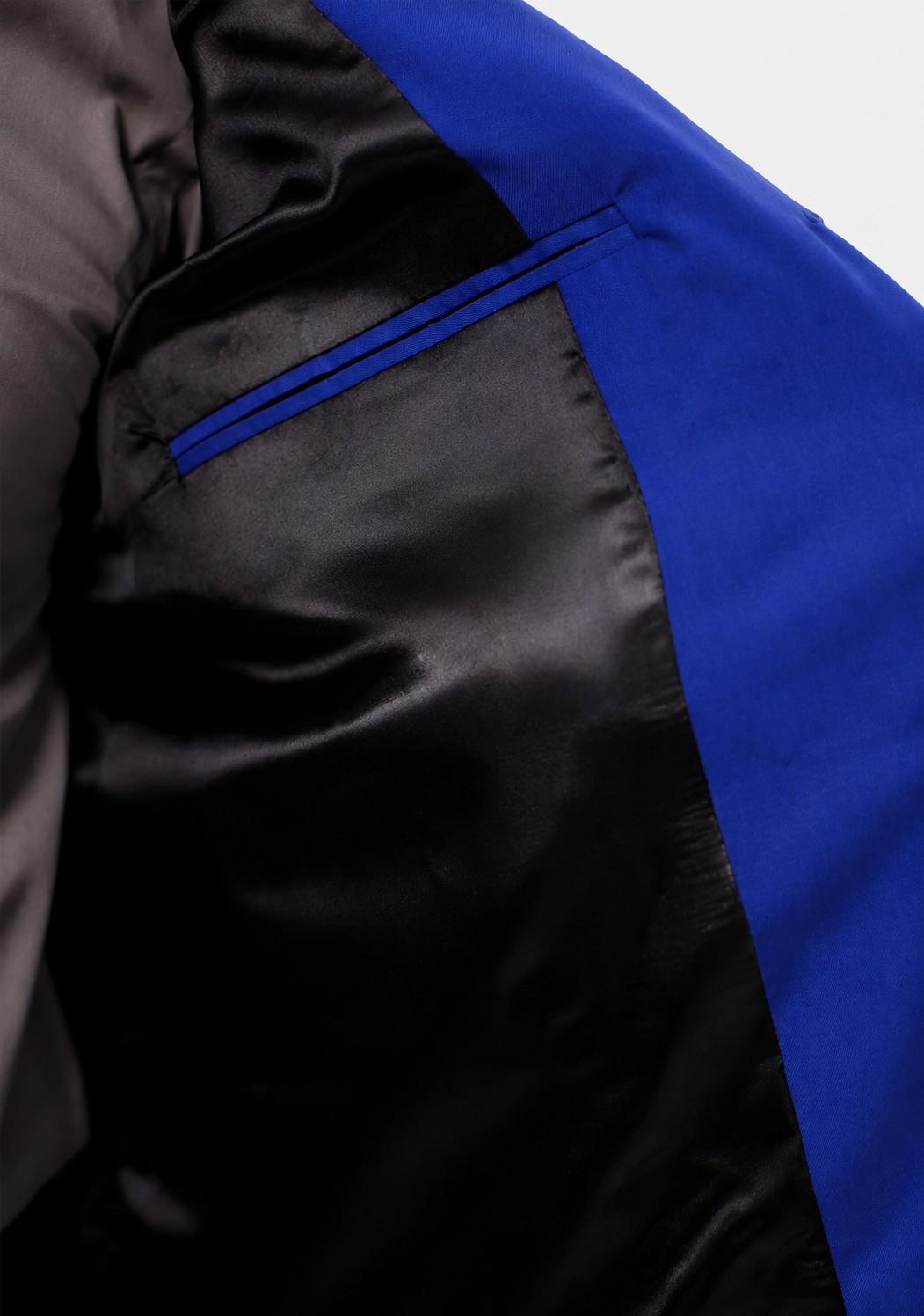  Man wearing a blue vest over a gray shirt on a white background
