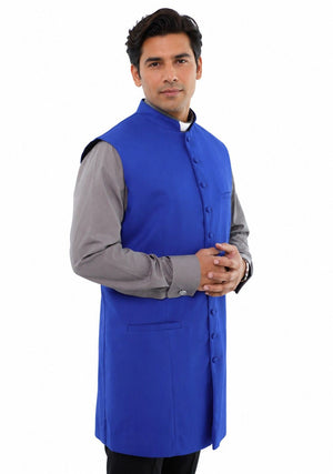 Man wearing a blue vest over a gray shirt on a white background