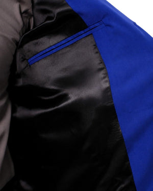 Man wearing a blue vest over a gray shirt on a white background