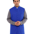 Man wearing a blue vest over a gray shirt on a white background