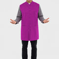 Man wearing a purple vest over a gray shirt on a white background