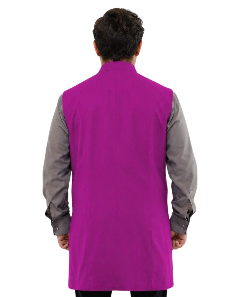 Man wearing a purple vest over a gray shirt on a white background