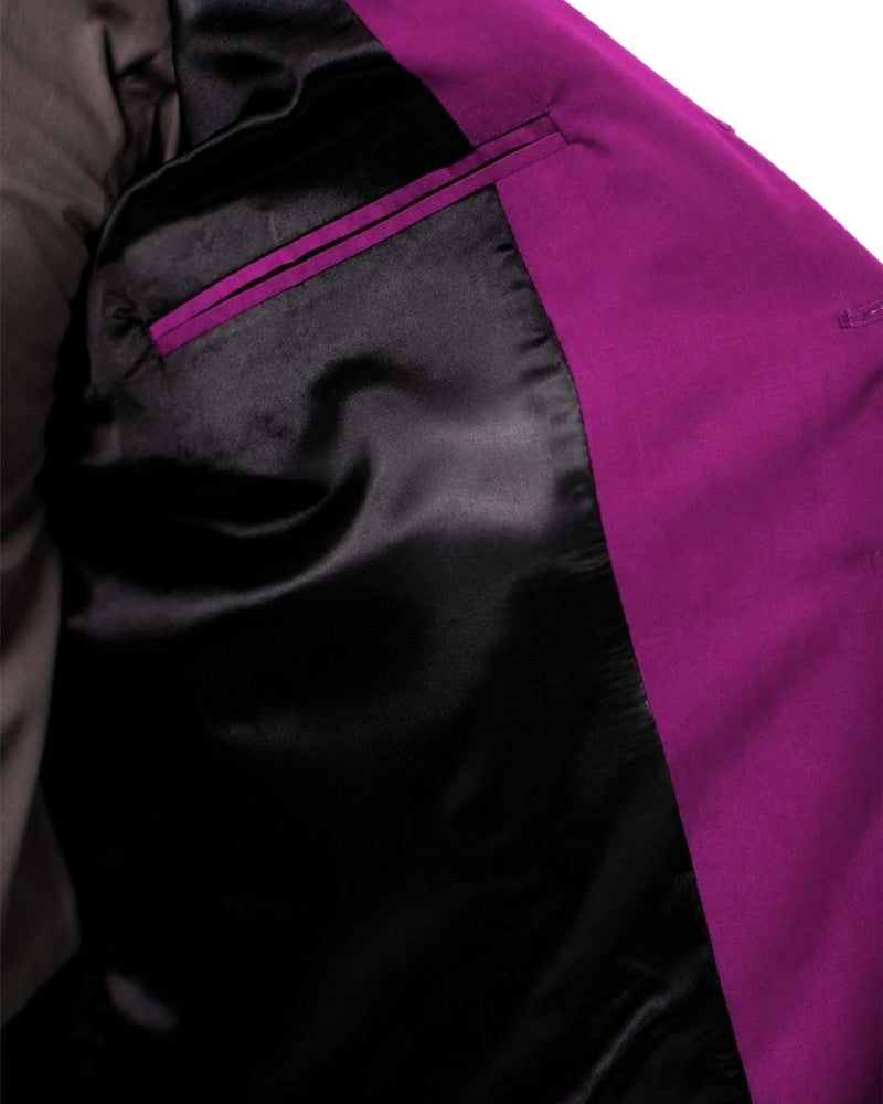 Man wearing a purple vest over a gray shirt on a white background
