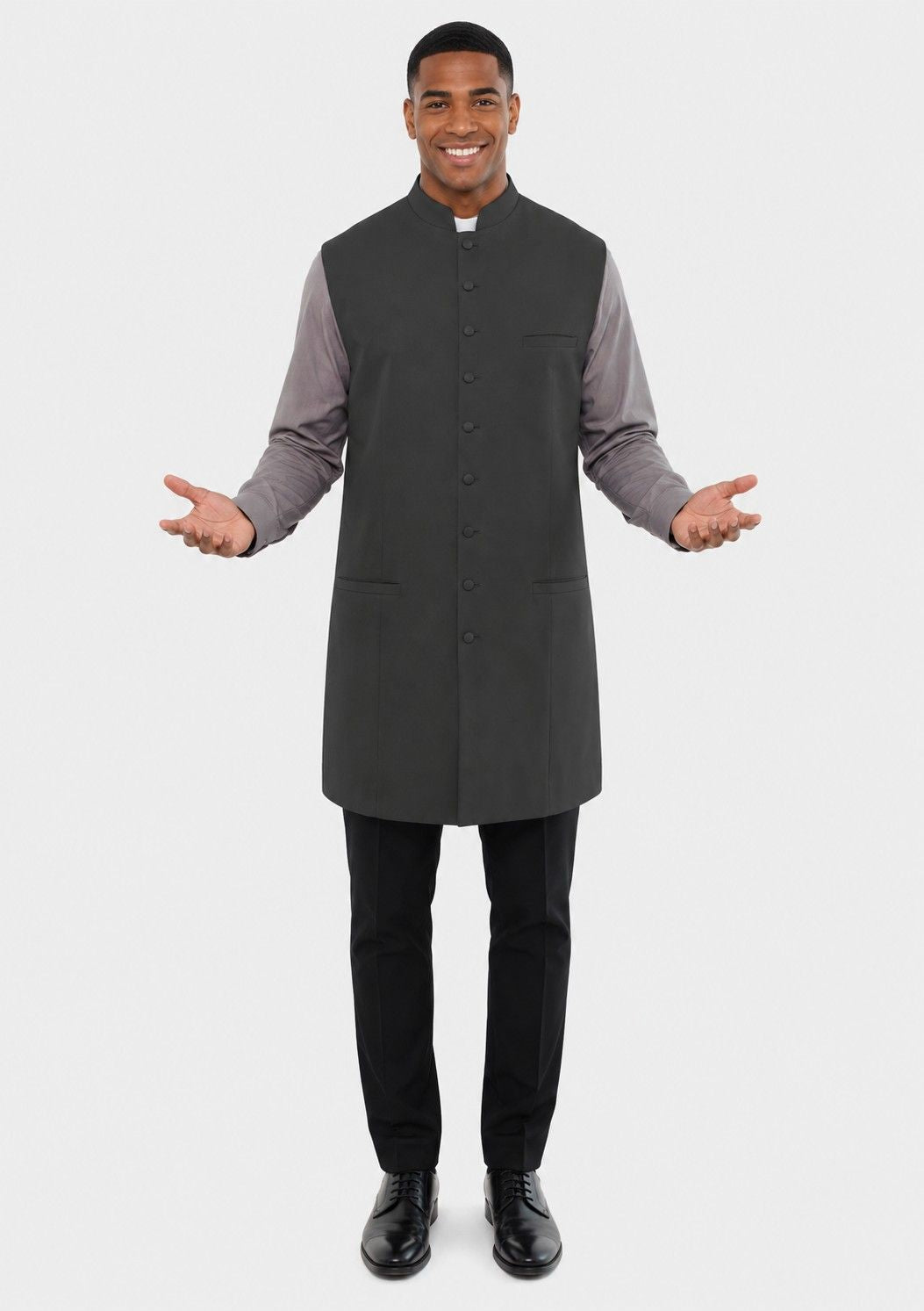 Man wearing a gray vest over a long-sleeve shirt on a white background