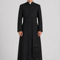 Man wearing a black priest's coat with a white background